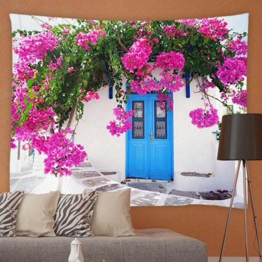 White Building With Blue Door And Pink Flowers Garden Tapestry - Clover Online